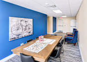 Thumbnail 5 of 20 - Community meeting room with dining table and artwork at The Ellison Apartments, Layton, Utah