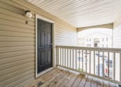 Thumbnail 20 of 26 - the front porch of a house with a black door