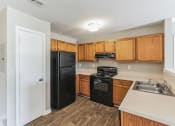 Thumbnail 8 of 26 - a kitchen with black appliances and wooden cabinets