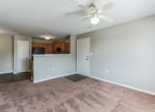 Thumbnail 2 of 26 - an empty living room with carpet and a ceiling fan