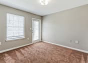Thumbnail 4 of 26 - an empty living room with a door and a window