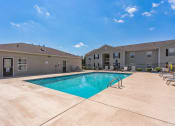 Thumbnail 22 of 26 - a view of a swimming pool with a blue sky above it