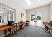 Thumbnail 6 of 10 - A room with a desk, chairs and computers.