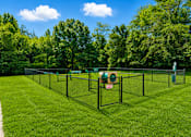Thumbnail 4 of 16 - A disc golf course with a green sign and a red sign on the tee.
