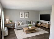Thumbnail 11 of 14 - A living room with a grey couch, a wooden coffee table, and a white fan.