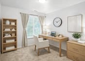 Thumbnail 12 of 12 - A room with a desk, chair, and shelf with towels.