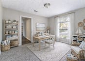 Thumbnail 14 of 17 - A cozy living room with a wooden table and chairs, a window with curtains, and a view of the outdoors. at Parkland at Orange Park Apartments , Florida, 32073