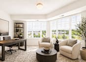 Thumbnail 2 of 5 - Home office with large windows and seating area at Lakewood Apartments, Lino Lakes, Minnesota