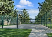 Thumbnail 2 of 9 - A fenced pathway in a park with trees on either side. at Diamond Fork Apartments, Spanish Fork, Utah