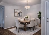 Thumbnail 9 of 10 - Dining room with wood table and upholstered chairs at Creekview Apartments, Utah