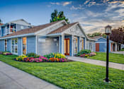 Thumbnail 1 of 10 - Leasing office exterior with colorful flower beds at Creekview Apartments, Utah, 84047