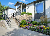 Thumbnail 1 of 12 - A house with a front yard and a stone wall.