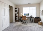 Thumbnail 9 of 11 - A home office with a desk, chair, and a painting on the wall at Haven Pointe Apartments, Utah