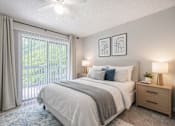 Thumbnail 10 of 13 - Bedroom with glass sliding doors at Brookwood, Archdale, NC, 27263