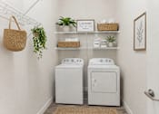 Thumbnail 11 of 13 - In unit laundry room with washer and dryer at Lake Ridge Apartments, Minnesota