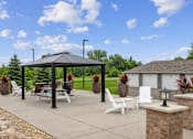 Thumbnail 1 of 13 - Outdoor gazebo with seating and planters at Lake Ridge Apartments, Prior Lake, MN