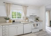 Thumbnail 5 of 8 - A white kitchen with a window and curtains.