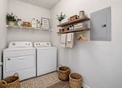 Thumbnail 16 of 17 - A laundry room with a washer and dryer and a basket on the floor.