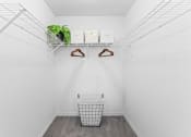 Thumbnail 13 of 23 - a laundry room with a basket and shelves and a plant