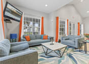 Thumbnail 16 of 23 - a living room with couches and chairs and a coffee table