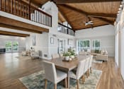Thumbnail 1 of 19 - A modern dining room with a wooden table and chairs.