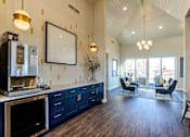 Thumbnail 24 of 25 - A kitchen with dark wood floors and a white ceiling.