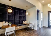 Thumbnail 22 of 25 - A modern dining area with a wooden table and chairs.