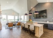 Thumbnail 21 of 25 - A kitchen with a dining table and chairs.