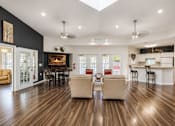 Thumbnail 11 of 21 - Clubhouse lounge with fireplace and kitchen bar at Northview Park Apartments, Sterling Heights, Michigan
