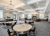 Thumbnail 8 of 20 - Spacious clubhouse lounge with fireplace and seating at The Ellison Apartments, Utah, 84041