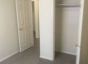 Thumbnail 8 of 16 - a bedroom with a closet and an open door