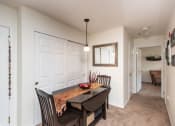 Thumbnail 3 of 23 - a living room with a kitchen and a dining table