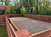 Thumbnail 35 of 56 - a backyard patio with a wooden fence and a sandbox