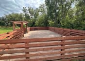 Thumbnail 34 of 56 - a fenced in area with a wooden fence