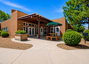 Thumbnail 7 of 24 - A building with a green awning and a bench in front of it.