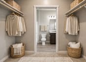 Thumbnail 19 of 21 - Walk-in closet with organized storage and bathroom access at Harper Ridge Apartments, Meridian