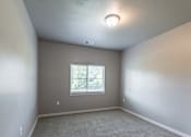 Thumbnail 14 of 29 - A room with a window and a ceiling light.