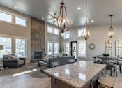 Thumbnail 24 of 29 - A modern kitchen with a large island and a dining table.