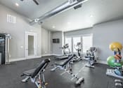 Thumbnail 20 of 29 - A spacious home gym with a variety of exercise equipment.