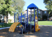 Thumbnail 10 of 13 - a playground with a blue playset and a yellow slide