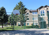 Thumbnail 12 of 16 - a basketball hoop in front of an apartment building