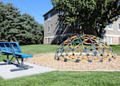 Thumbnail 11 of 16 - a playground in a yard in front of a house with a tree and a chair