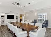Thumbnail 16 of 17 - a large dining room with a wooden table and white chairs