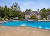 Thumbnail 11 of 17 - a swimming pool with a house in the background