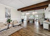 Thumbnail 27 of 28 - the living room and dining area of a home with a wood floor and white walls
