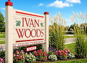 Thumbnail 1 of 2 - A sign for Ivan Woods Senior Community with a red and green design on the top left.