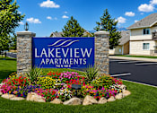 Thumbnail 1 of 5 - Lakeview Apartments sign with flowers in front.
