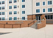 Thumbnail 1 of 5 - Property entrance sign with brick facade at Lakewood Apartments, Lino Lakes