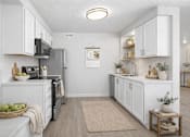 Thumbnail 2 of 6 - Modern galley kitchen with white cabinets at Fort Lane Apartments, Layton, Utah