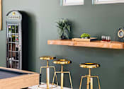 Thumbnail 14 of 24 - Bar area with wood shelf and gold stools at Lofts at Innovation Center Apartments, Washington, 99354